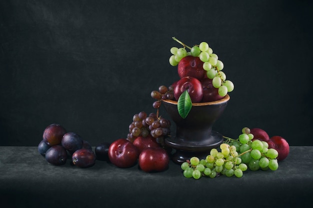 Still life with ripe grapes and plums