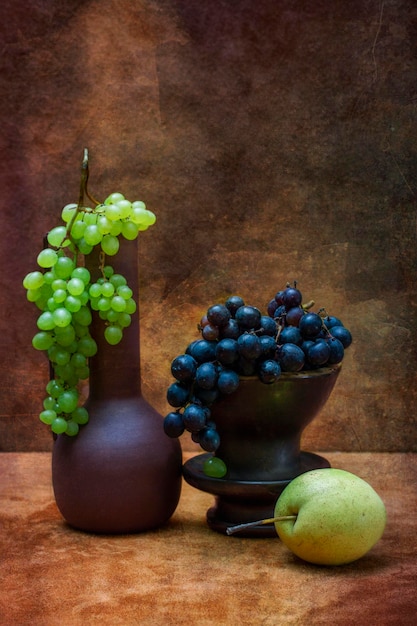 Still life with ripe pear and grapes