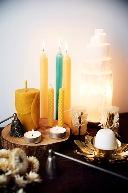 Still life with several natural beeswax candles selenite lamp and two candle snuffers