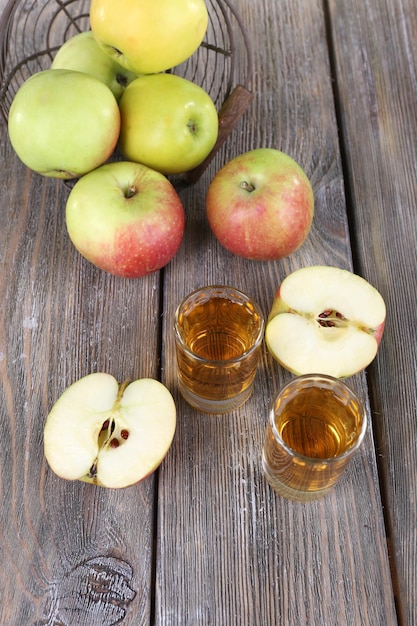 Still life with tasty apple cider in barrel and fresh apples