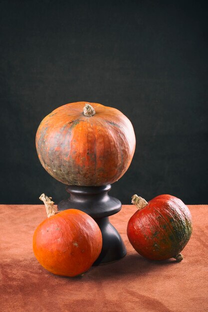 Still life with tree ripe pumpkins on the table