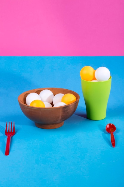 Still life with a vase and a glass with colorful balls