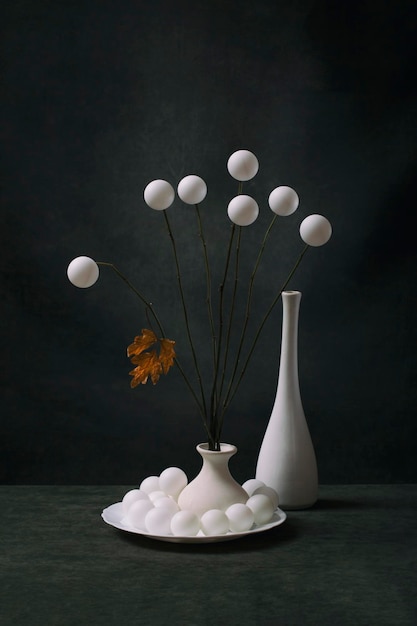 Still life with white balls in a white vase