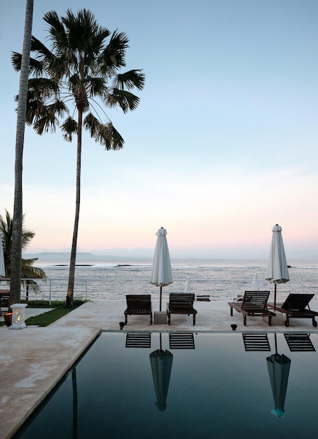 still pool and deckchairs at a luxury resort at sunset