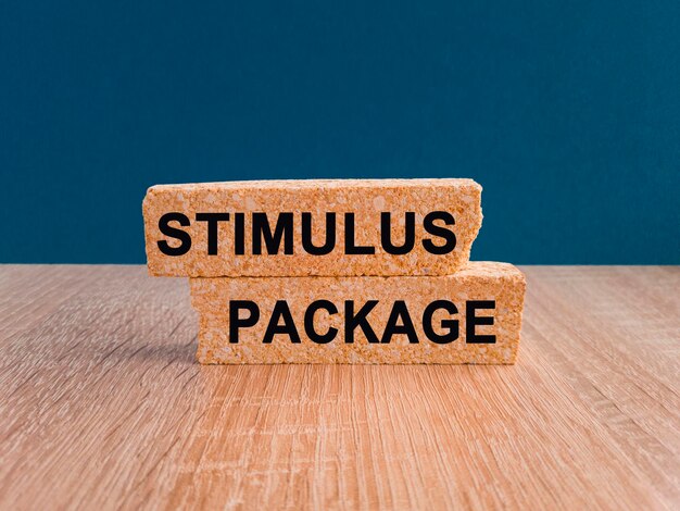 Stimulus package symbol Concept words stimulus package on wooden blocks Beautiful wooden table