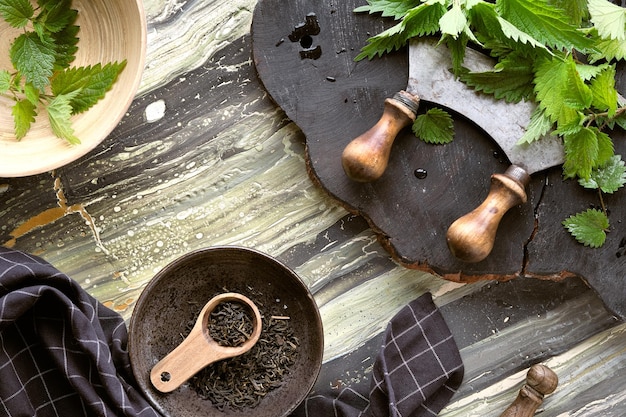 Stinging nettle fresh herbs herb knife on rustic wooden board Dry nettle herb herbal tea