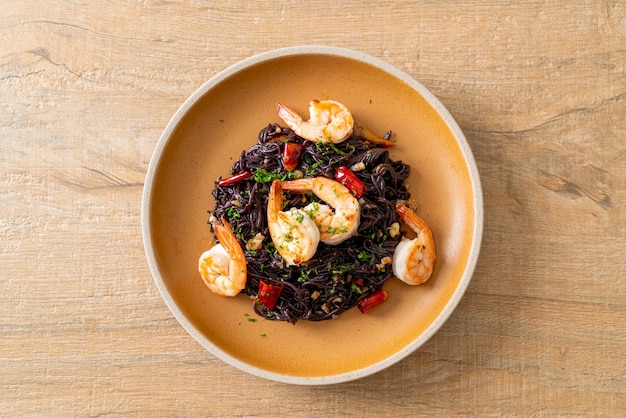 stir-fried black spaghetti with garlic and shrimps on plate