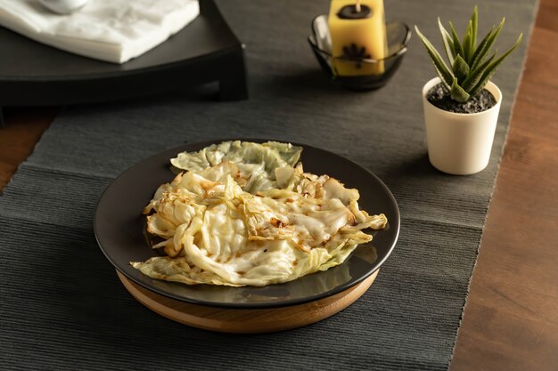 stir fried cabbage with fish sauce served in a black dish