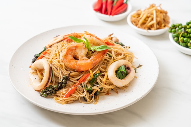 stir-fried Chinese noodle with basil, chilli, shrimps and squid, Asian food style