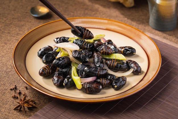 Stir-fried cocoon pupae is a special food in northeast China