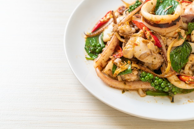 stir fried holy basil with octopus or squid and herb, Asian food style