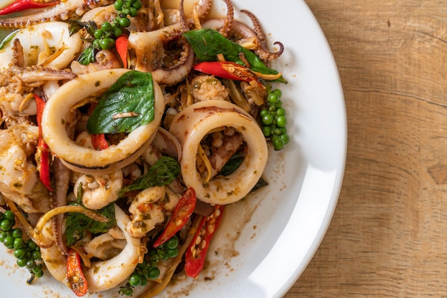 stir fried holy basil with octopus or squid and herb, Asian food style