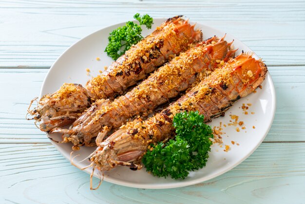 Stir Fried Mantis Shrimp with Garlic on white plate