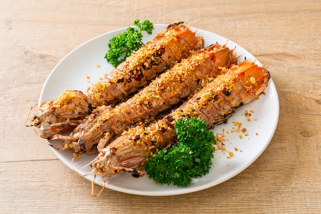 stir-fried Mantis Shrimp with Garlic on white plate
