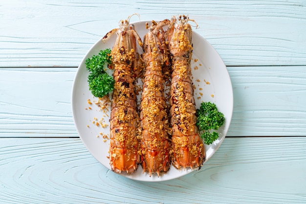 stir-fried Mantis Shrimp with Garlic on white plate