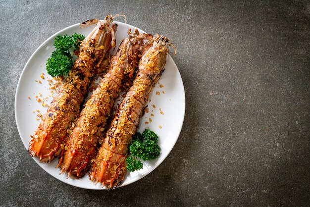 Stir Fried Mantis Shrimp with Garlic on white plate