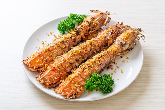 Stir Fried Mantis Shrimp with Garlic on white plate