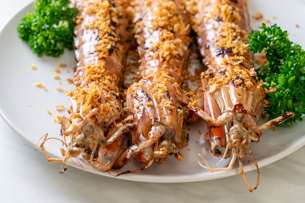 Stir Fried Mantis Shrimp with Garlic on white plate