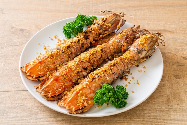 Stir Fried Mantis Shrimp with Garlic on white plate