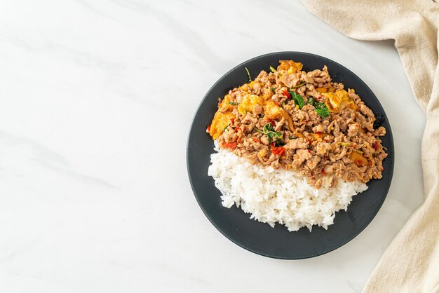 stir-fried minced pork with basil and egg topped on rice - Asian food style