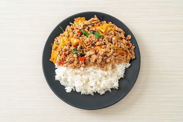 stir-fried minced pork with basil and egg topped on rice - Asian food style