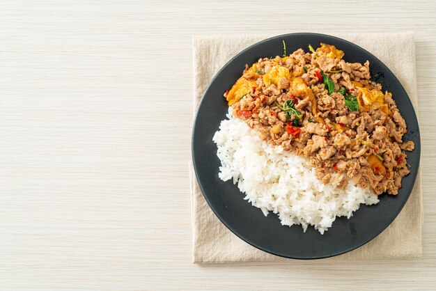 stir-fried minced pork with basil and egg topped on rice - Asian food style