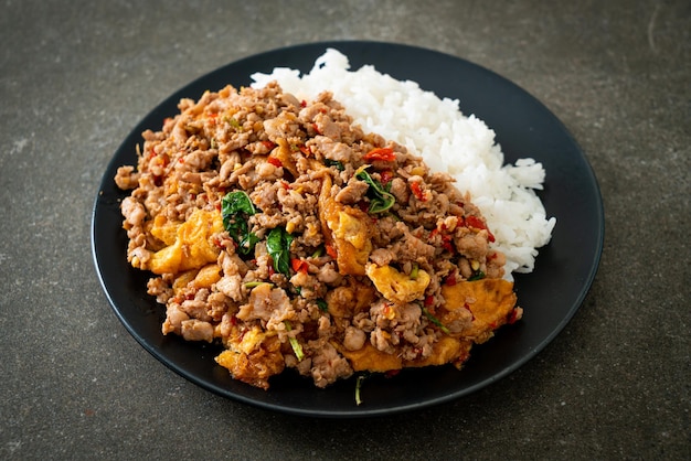 stir-fried minced pork with basil and egg topped on rice - Asian food style