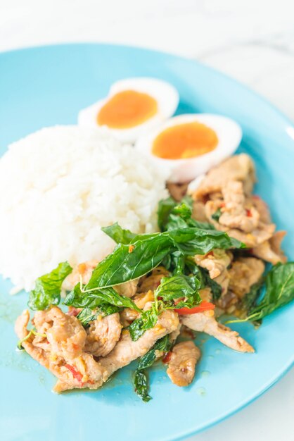 stir-fried pork and basil with egg and rice