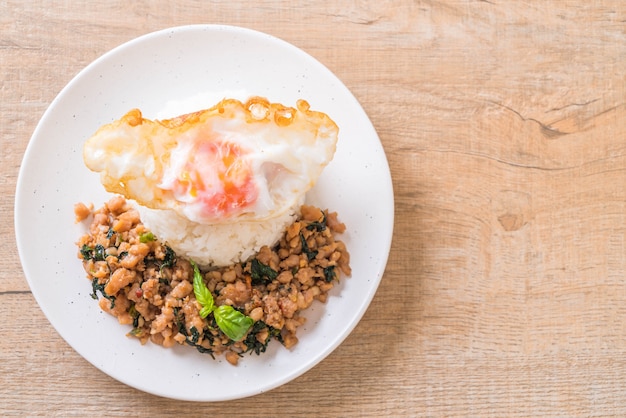 stir-fried pork with basil  on rice and fried egg