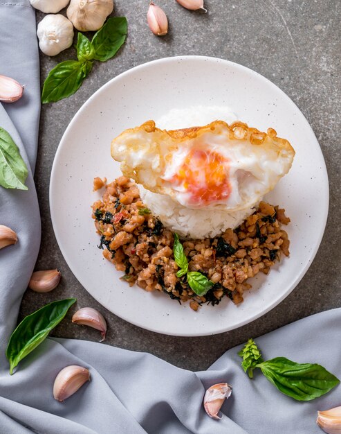 stir-fried pork with basil  on rice and fried egg