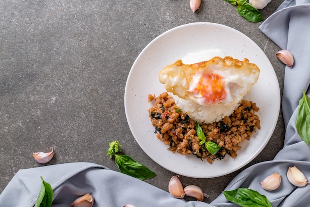 stir-fried pork with basil  on rice and fried egg