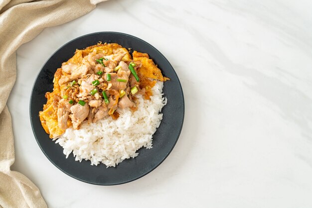 stir-fried pork with garlic and egg topped on rice - Asian food style