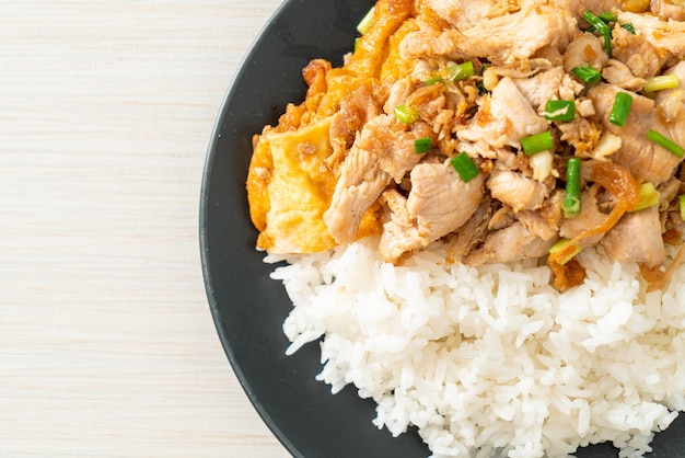 stir-fried pork with garlic and egg topped on rice - Asian food style