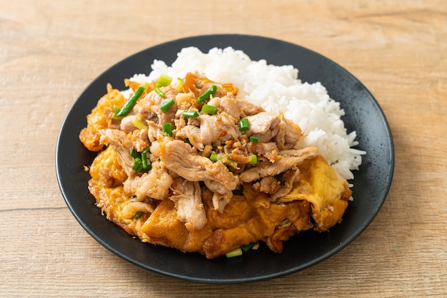 stir-fried pork with garlic and egg topped on rice - Asian food style