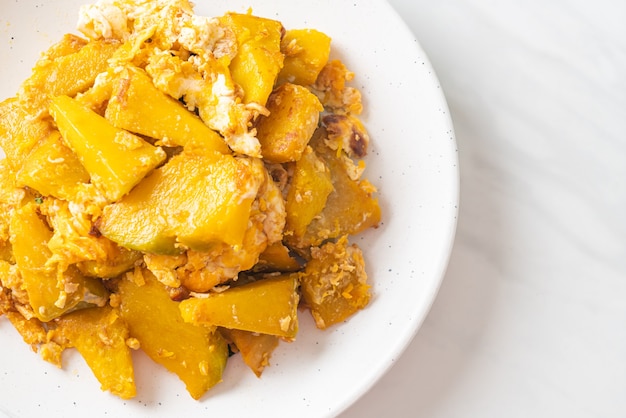 Stir Fried Pumpkin with Egg on white plate