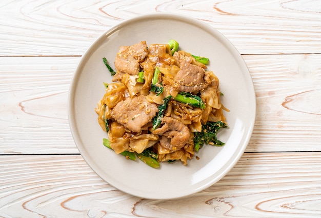 Stir-fried rice noodle with black soy sauce and pork and kale