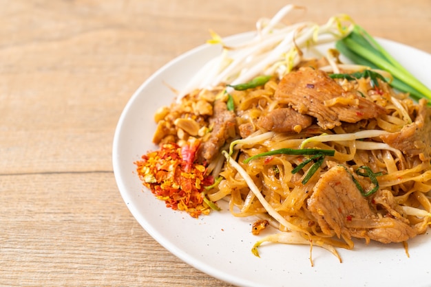 stir-fried rice noodles with pork in Asian style