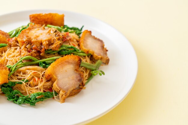 Stir-fried rice vermicelli and water mimosa with crispy pork belly - Asian food style