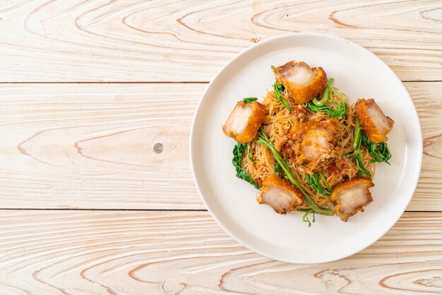 Stir-fried rice vermicelli and water mimosa with crispy pork belly