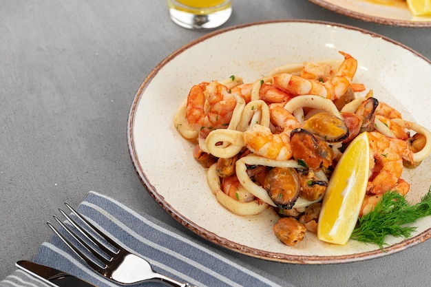 Stir fried seafood with sauce on plate with napkin close up