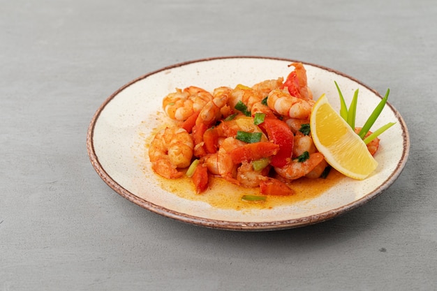 Stir fried seafood with sauce on plate with napkin