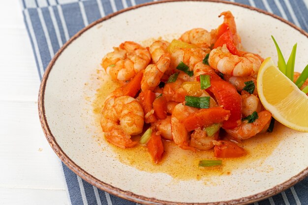 Stir fried seafood with sauce on plate with napkin