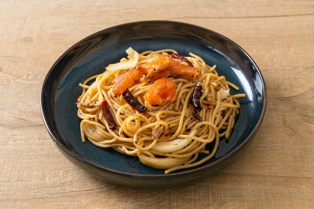 stir-fried spaghetti with salmon and dried chilli - fusion food style