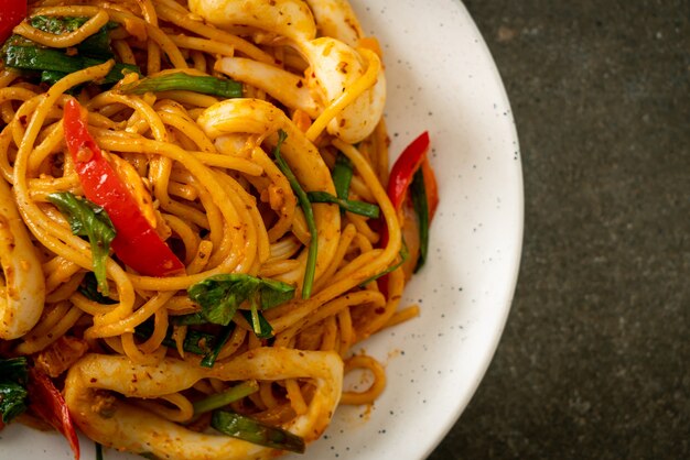 stir-fried spaghetti with salted egg and squid - fusion food style