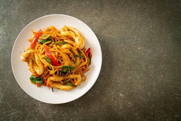 stir-fried spaghetti with salted egg and squid - fusion food style