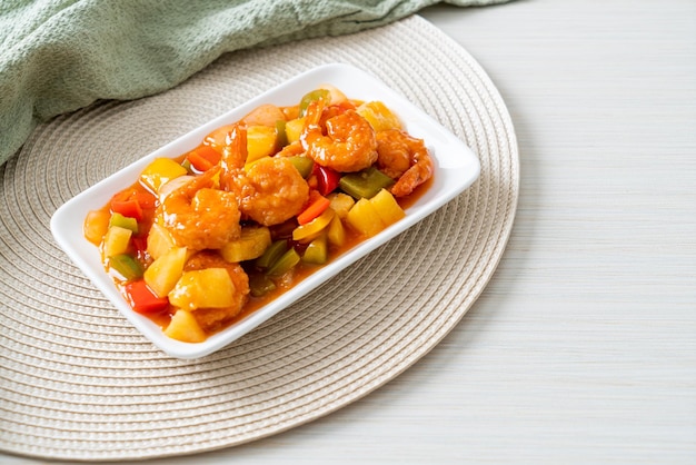 Stir-fried sweet and sour with fried shrimp on plate - Asian food style