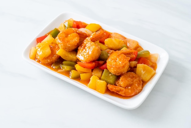 Stir-fried sweet and sour with fried shrimp on plate - Asian food style