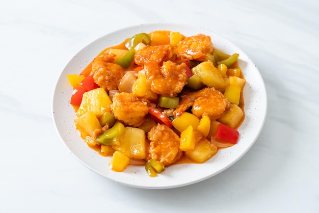 Stir-fried sweet and sour with fried shrimp on plate - Asian food style