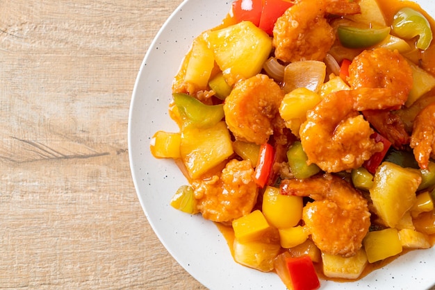 Stir-fried sweet and sour with fried shrimp on plate - Asian food style