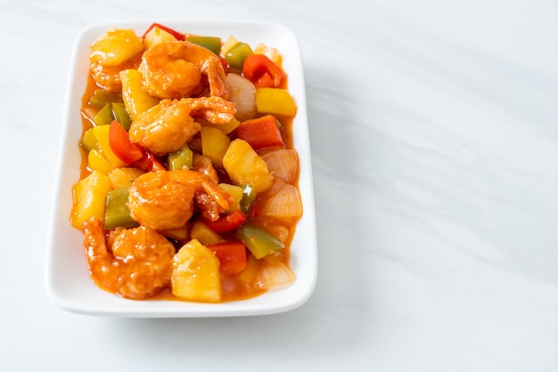 Stir-fried sweet and sour with fried shrimp on plate - Asian food style